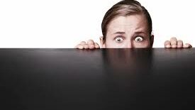 man hiding behind screen